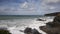 White waves breaking on the rocks Trebarwith Strand Cornwall England UK coast village between Tintagel and Port Isaac pan