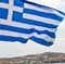 white waving greece flag in the blue sky and flagpole