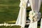 White wedding arch with flowers on sunny day in ceremony place