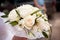 White wedding Bridal bouquet of cream roses, intertwined with grass