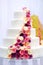 White wedding cake decorated with sugar flowers