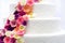 White wedding cake decorated with sugar flowers