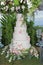 White wedding cake with flowers. Beach wedding