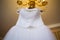 White wedding dress hanging on the chandelier. bride accessories. charges of the bride. bride`s morning