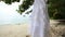 white wedding dress hangs on island