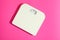 White weigh scales on pink background