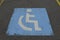White wheelchair stickman on blue background
