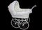 White wicker doll or baby pram on a black background