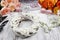 White wicker wreath decorated with tiny daisies