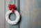 White wicker wreath on wooden door