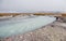 White wide rapid river amid valley on a background of rocky hill