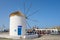 White windmill overlooking Parikia port on Paros island, Greece