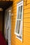 White window and antique lantern on yellow cottage