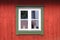 White window in a red wooden wall