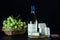 White wine bottle, blue cheese and a bunch of ripe grapes on a black background