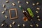 White wine bottle, bunch of grapes, wineglass with corks, corkscrew and chalk board on black background