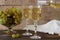 White wine with glass goblets and grape bunches on a wooden background.