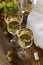 White wine with glass goblets and grape bunches on a wooden background.