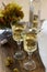 White wine with glass goblets and grape bunches on a wooden background.