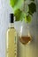White wine and grapevine on a white wooden background