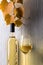 White wine and grapevine on a white wooden background