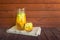 White wine sangria with fruits in glass and pitcher. Homemade refreshing sangria on rustic wooden table