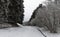 White winter landscape in snow and a winding road