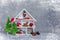 White winter magical wooden cupboard with christmas toys and presents, cone, alarm clock, branches of fir-tree, postcard