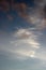 White wispy cirrus clouds pink tinged clouds below