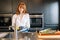 White woman with gloves cleaned dishes in kitchen