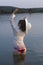 White woman in sun hat posture on beach lake