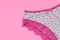 White women underwear with lace on pink background with copy space. Beauty fashion blogger concept. Romantic lingerie for