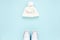 White women winter the boots and hat, glasses isolated on blue background. Flat lay, top view trendy fashion feminine