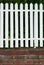 White Wood Fence with Brick Base