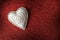 White wood valentine heart on red background, valentines day or celebrating love