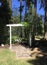 White wooden archway in wooded area