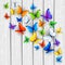 White wooden background with multicolored butterflies