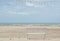 White wooden bench at beach decorated with vintage light bulbs