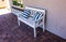 White Wooden Bench With Striped Pillows On Outside Patio