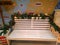 White wooden bench, which is decorated with pine branches with Christmas decorations