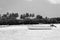 White wooden boat on white sand shallow, black and white. Low tide landscape with white boat. Sailboats at the beach.