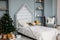 The white wooden children bed with pillows and toys. Minimalistic Christmas decor. Scandinavian bright interior