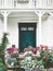 White wooden country house entrance door terrace cozy exterior with flowers