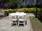 White wooden dining table in the green garden