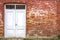 White wooden door at red brick wall