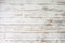 White wooden floorboards. Distressed worn floorboard background painted white