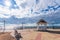 White wooden gazebo and lake bench under a dramatic sunset sky. Settlement Turka, Baikal tourist zone. Siberia, Buryatia, Russia