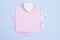 White wooden heart and pastel pink blank card mockup on pastel blue background with scattered pink glitter stars. Place for your