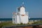 White wooden house the lifeguard stands on a beach and the sky is blue