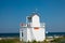 White wooden house the lifeguard stands on a beach and the sky is blue